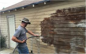 Dustless blasting paint off a wood siding house