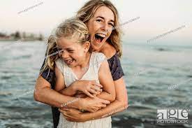 A girl hugs his freckled mother